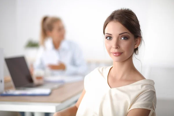 Attractive young businesswoman standing  near desk in office — Stock Photo, Image