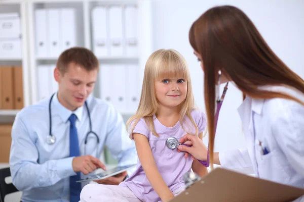 Female doctor examining child with stethoscope at surgery — Stock Photo, Image