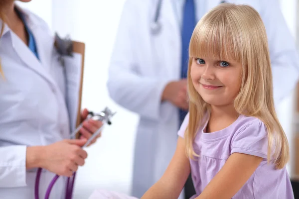 Female doctor examining child with stethoscope at surgery — Stock Photo, Image