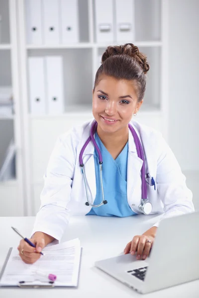 Doctor and patient sitting on the desk  at office — Stock Photo, Image