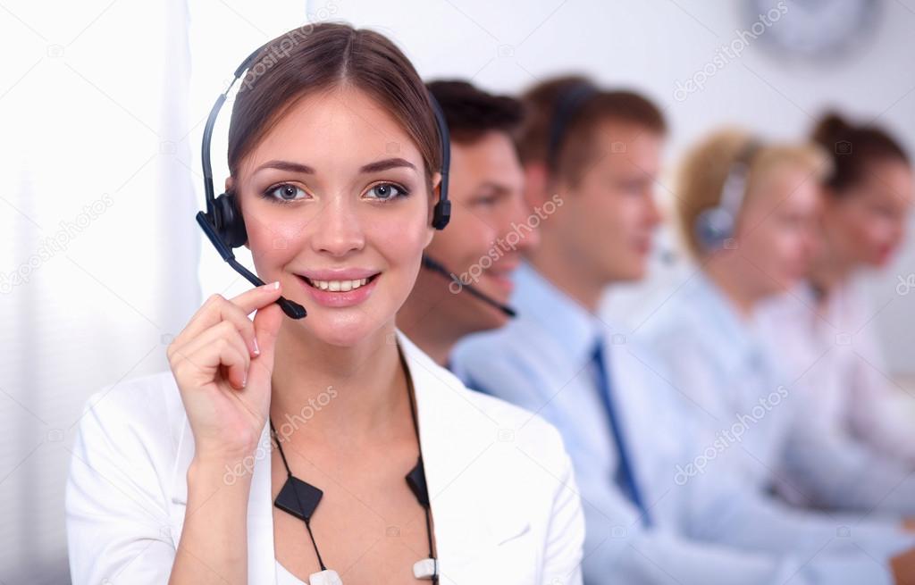 Attractive Smiling positive young businesspeople and colleagues in a call center office