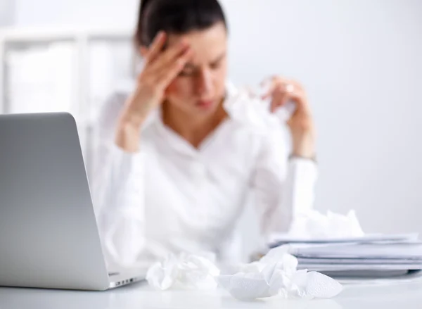 Gestresste Geschäftsfrau sitzt am Schreibtisch im Büro — Stockfoto