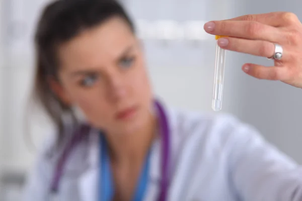 Woman researcher is surrounded by medical vials and flasks, isolated on white background — Stock Photo, Image