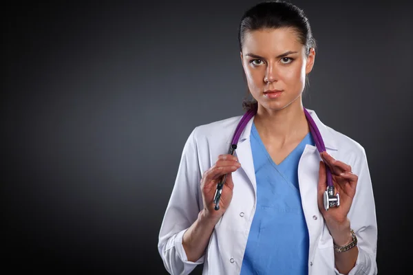 Jeune médecin femme avec stéthoscope isolé sur gris — Photo