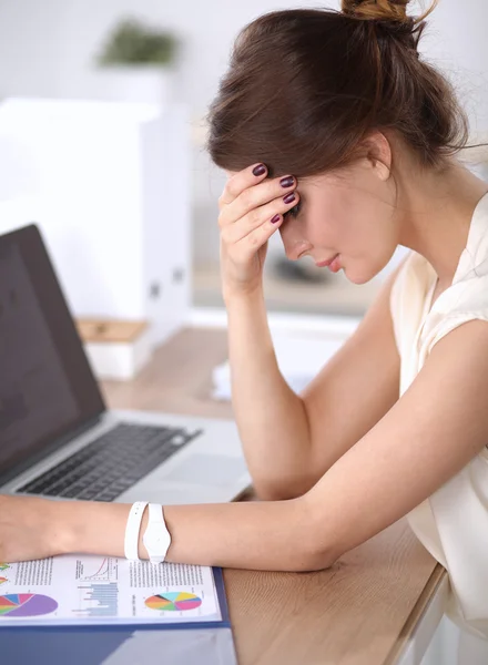 Portrait of tired young business woman with laptop computer at the office — Stock Photo, Image