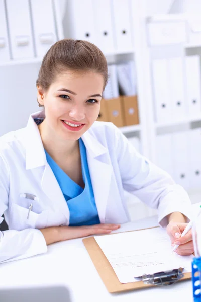 Woman researcher is surrounded by medical vials and flasks, isolated on white background — Stock Photo, Image