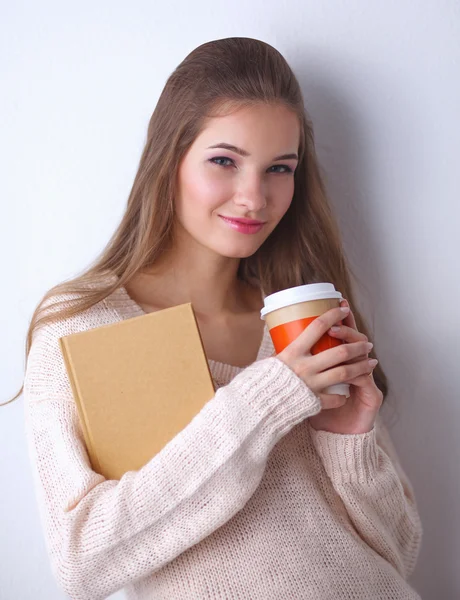 Portrait  a young woman with cup of tea or coffee, holding book — Stock Photo, Image