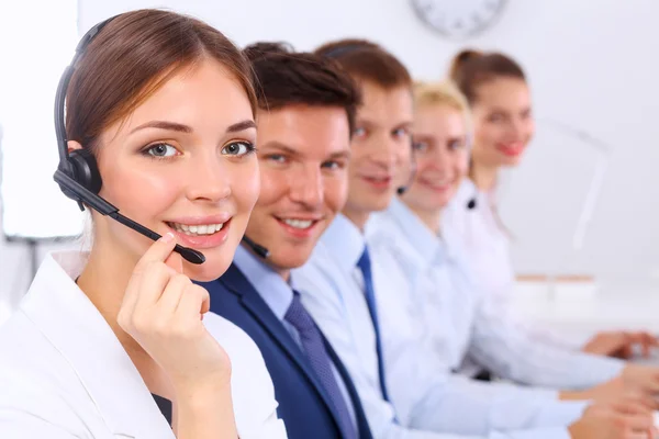 Attractive Smiling positive young businesspeople and colleagues in a call center office — Stock Photo, Image