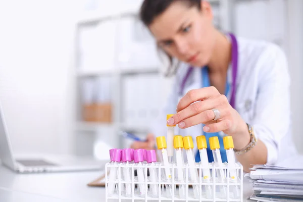 Vrouwelijke onderzoeker is omringd door medische flacons en flacons, geïsoleerd op witte achtergrond — Stockfoto