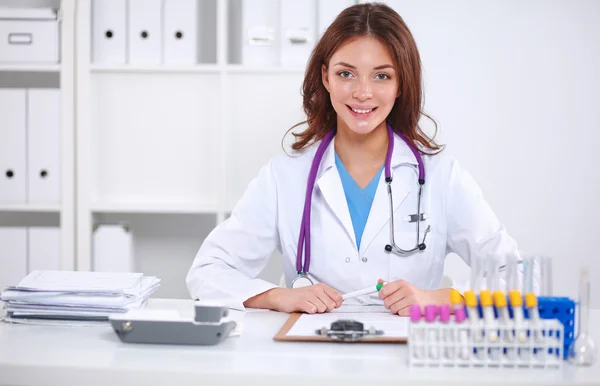 Woman researcher is surrounded by medical vials and flasks, isolated on white background — Stock Photo, Image