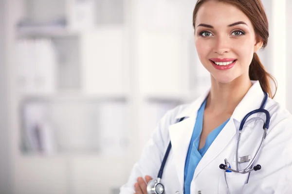 Portrait of young woman doctor with white coat standing in hospital — Stock Photo, Image