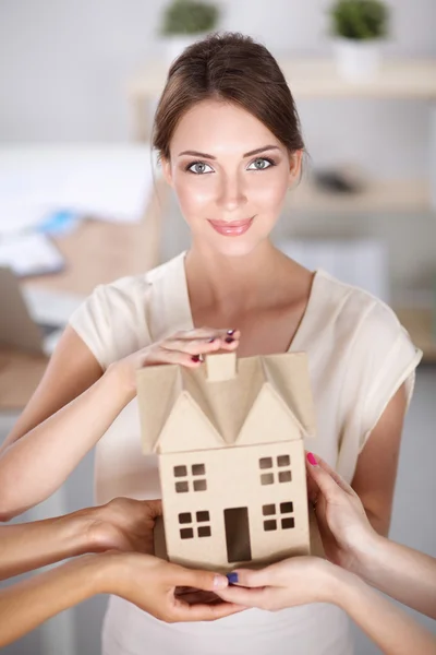 Portrait of female architect with blueprints at desk in office — Stock Photo, Image