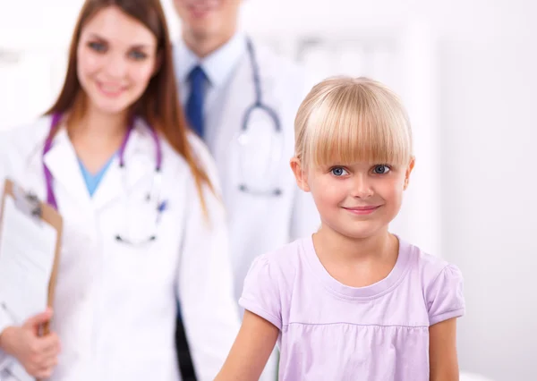 Female doctor examining child with stethoscope at surgery — Stock Photo, Image