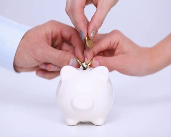 Putting coin into the piggy bank — Stock Photo, Image