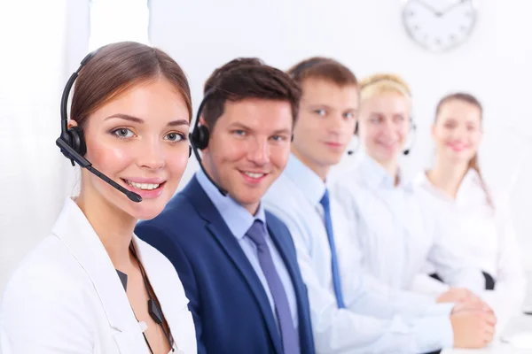 Attractive Smiling positive young businesspeople and colleagues in a call center office — Stock Photo, Image