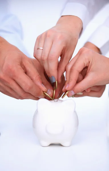 Putting coin into the piggy bank — Stock Photo, Image