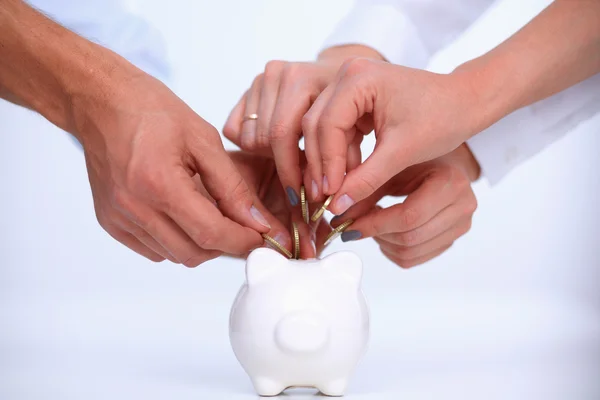 Putting coin into the piggy bank — Stock Photo, Image