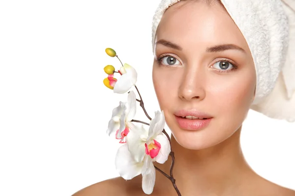 Portrait of beautiful girl touching her face with a towel on  head — Stock Photo, Image