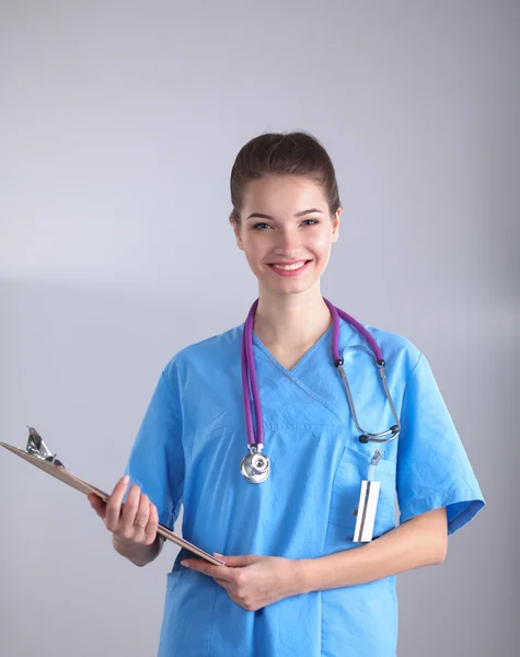 Uśmiechnięta lekarka w mundurze stojąca w szpitalu — Zdjęcie stockowe