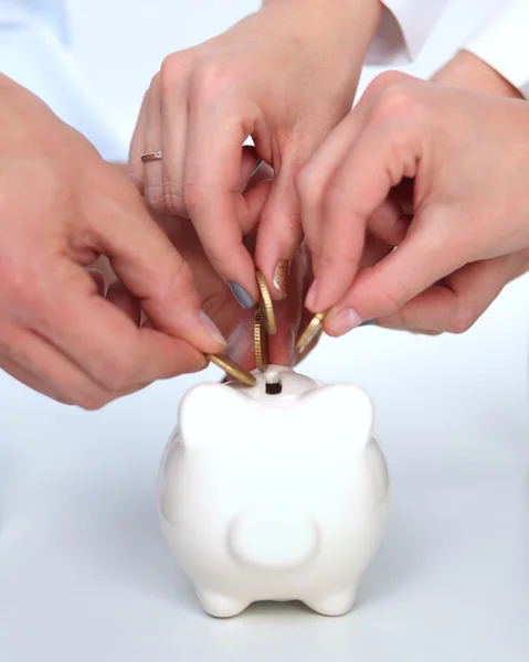 Putting coin into the piggy bank — Stock Photo, Image