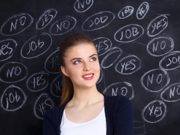 Thinking young woman with yes or no choice on grey background — Stock Photo, Image