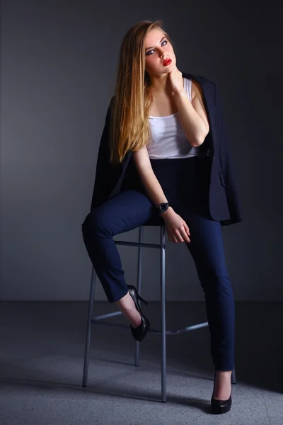 Young woman sitting on a chair — Stock Photo, Image