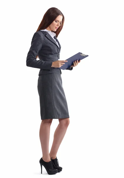 Attractive young businesswoman standing near desk with folder in the office — Stock Photo, Image