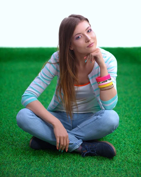 Young woman sitting  on green grass — Stock Photo, Image