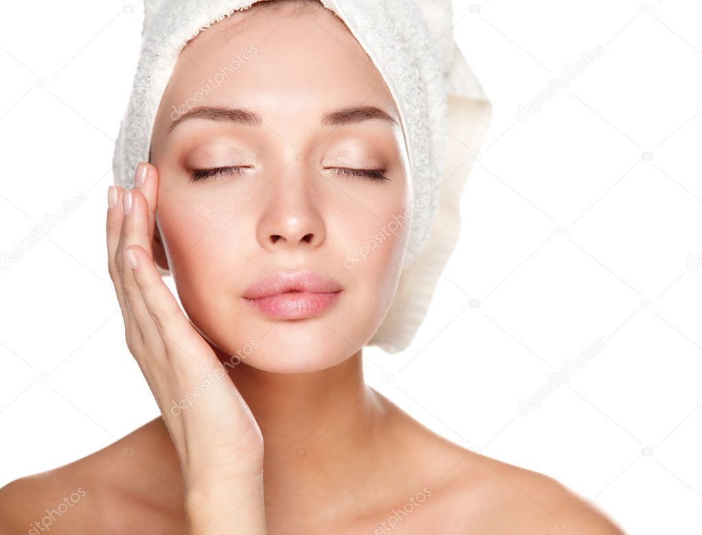 Portrait of beautiful girl touching her face with a towel on  head