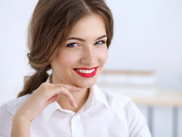 Attractive businesswoman sitting  in the office — Stock Photo, Image