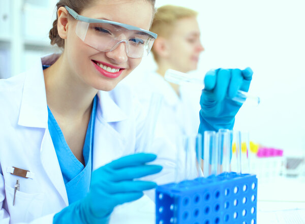 Woman researcher is surrounded by medical vials and flasks, isolated on white background