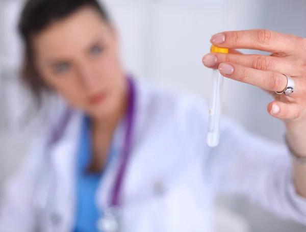 Woman researcher is surrounded by medical vials and flasks — Stock Photo, Image