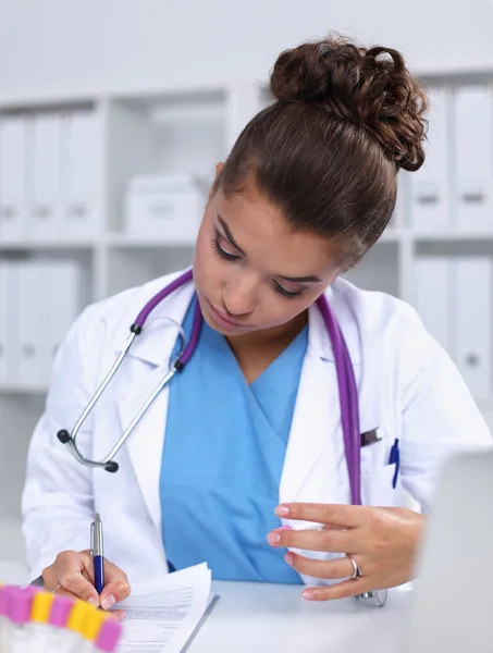 Woman researcher is surrounded by medical vials and flasks, isolated on white background — Stock Photo, Image