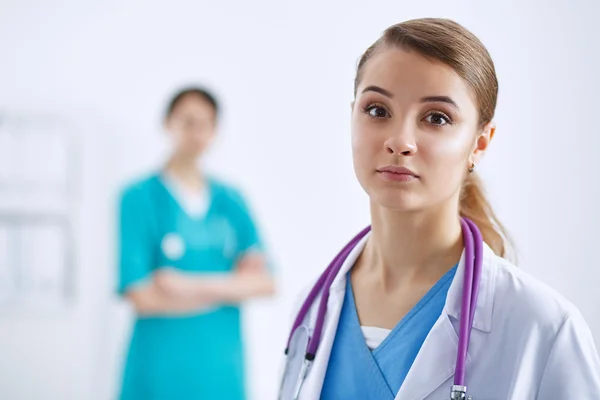 Woman doctor standing with stethoscope at hospital — Stock Photo, Image