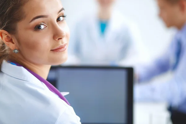 Medical team sitting at the table in modern hospital — Stock Photo, Image