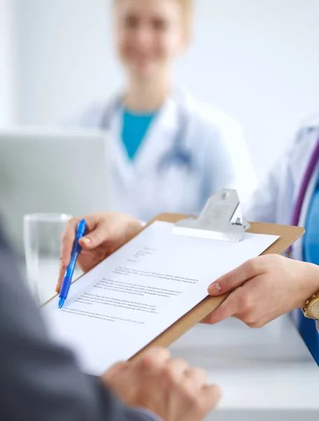 Medical team sitting at the table in modern hospital — Stock Photo, Image