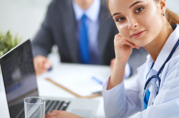 Medical team sitting at the table in modern hospital — Stock Photo, Image