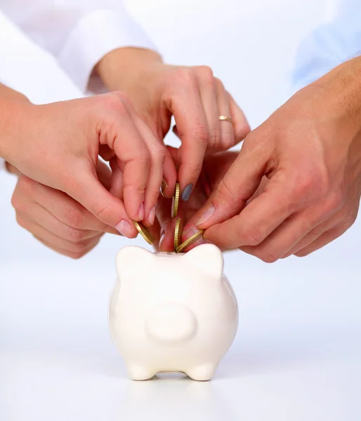 Putting coin into the piggy bank — Stock Photo, Image