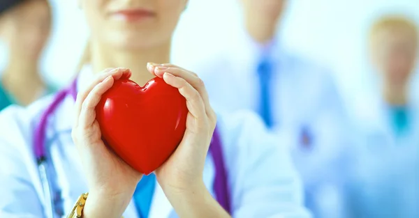 Female doctor with stethoscope holding heart — Stock Photo, Image