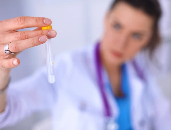 Woman researcher is surrounded by medical vials and flasks — Stock Photo, Image