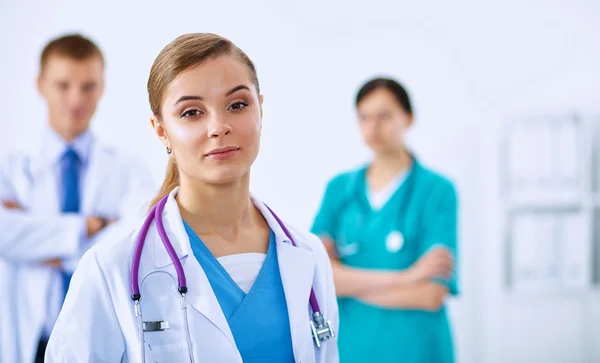 Woman doctor standing with stethoscope at hospital — Stock Photo, Image