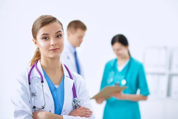 Woman doctor standing with stethoscope at hospital — Stock Photo, Image