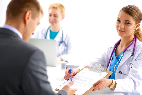 Medical team sitting at the table in modern hospital — Stock Photo, Image