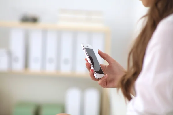 Empresaria enviando mensaje con teléfono inteligente en la oficina — Foto de Stock