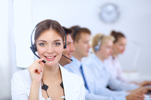 Attractive positive young businesspeople and colleagues in a call center office