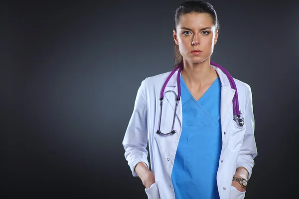 Mujer doctora joven con estetoscopio aislado sobre fondo gris — Foto de Stock