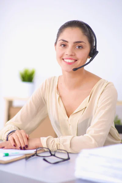 Portrait of beautiful business woman working at her desk with headset and laptop — Stock Photo, Image