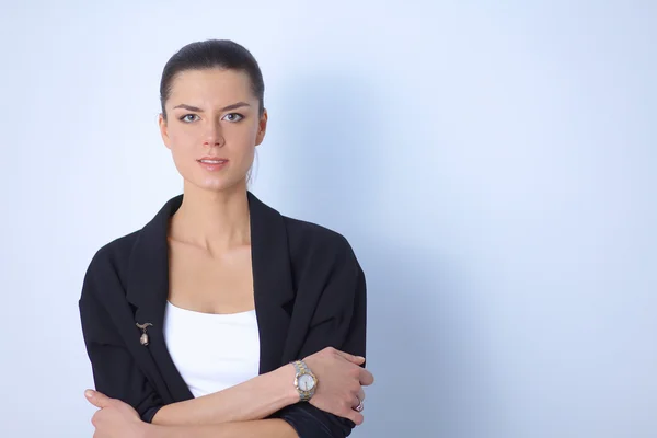 Young woman standing, isolated on gray background — Stock Photo, Image