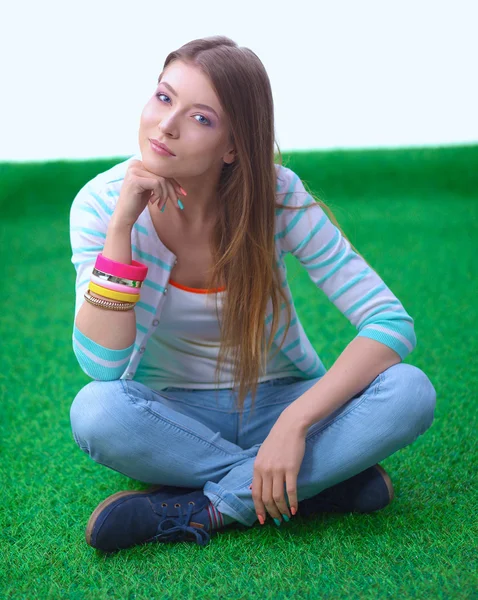 Young woman sitting  on green grass — Stock Photo, Image