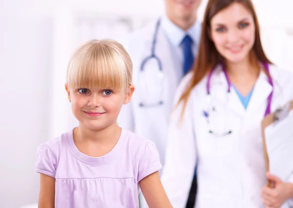 Female doctor examining child with stethoscope at surgery — Stock Photo, Image